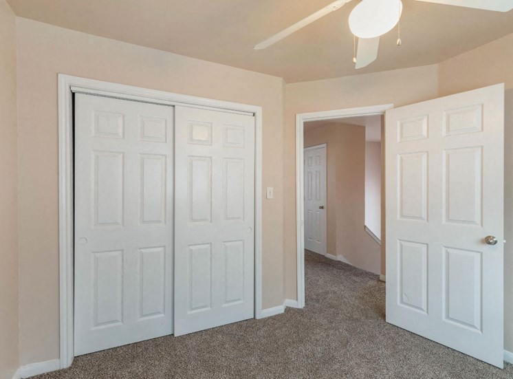 Bedroom with wall to wall carpet and ceiling fan